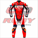 Front-facing image of Luca Mariniās Honda Castrol 2025 MotoGP race suit, detailed in red and black with Honda, VR46, and Castrol logos. Designed by RUBY, the suit includes shoulder and knee protection, personalized with the 'M' emblem.